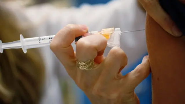 A paediatrician administers a vaccine in Florida, US