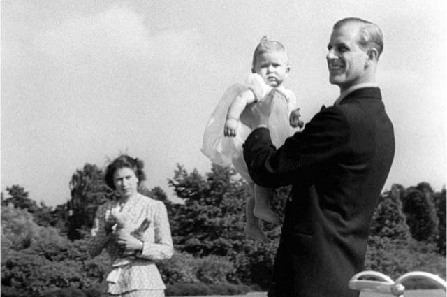 Prince Charles being lifted up by his father The Duke of Edinburgh