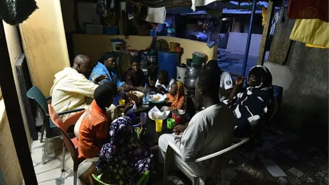 A Muslim family shares an Iftar meal as they break their fast on the first day of the holy month of Ramadan in Abobo, Abidjan, on April 24, 2020. (Photo by Sia KAMBOU / AFP) (Photo by SIA KAMBOU/AFP via Getty Images)