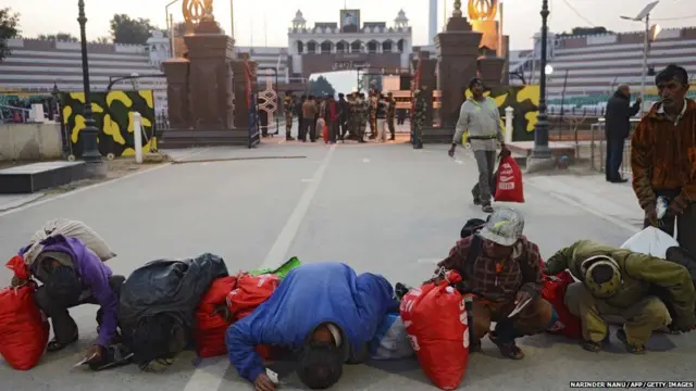 7. Indian fishermen released by Pakistani authorities kiss the ground after crossing the India-Pakistan Wagah border, some 35kms west of Amritsar on January 8, 2018. Pakistan on January 7 released at least 147 Indian fishermen, held for trespassing into its territorial waters, from Karachi's Malir Jail as a goodwill gesture