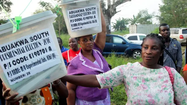 Polling agents carry electoral materials