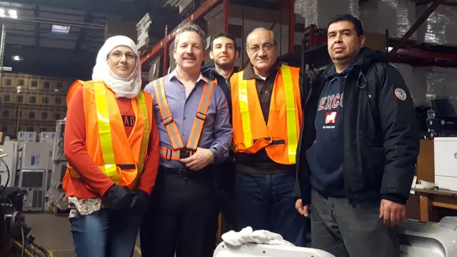 Jim Estill avec des réfugiés syriens qui travaillent maintenant pour Danby