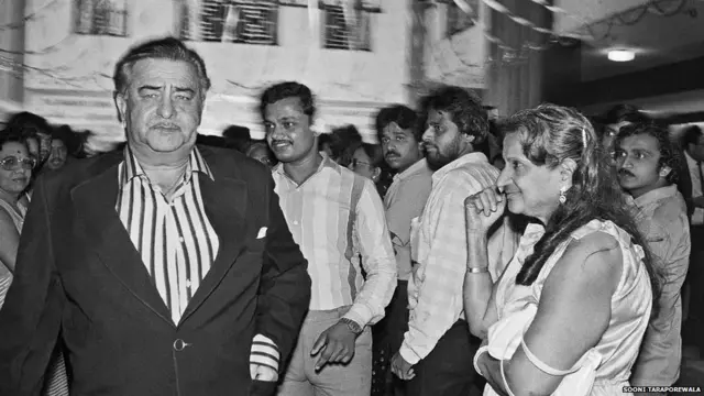 Actor Raj Kapoor at the premiere of Janbaaz while a fan gazes at him