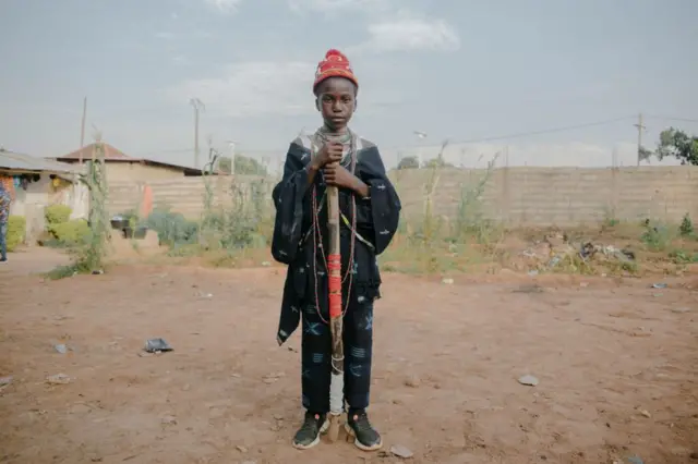 Irvem, 11, poses for a portrait during a Diola circumcision ceremony in Bissau on November 14, 2021. - Irvem wears traditional indigo clothing as he is one of six men celebrating his recent circumcision. The Diola are a West African ethnic group living in Gambia, southern Senegal and Guinea-Bissau