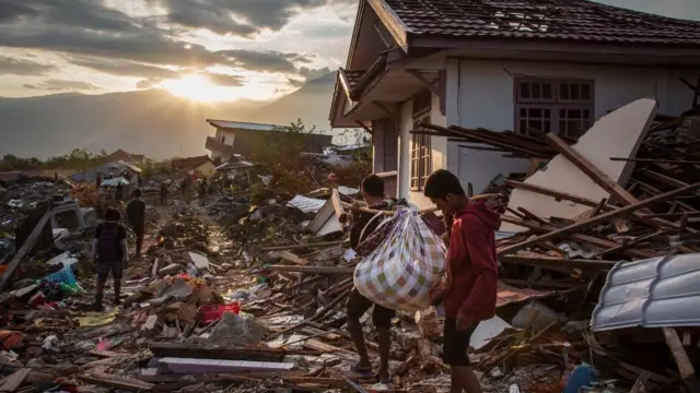 Para penyintas di Kelurahan Petobo mengais-ngais puing untuk mencari kerabat dan harta benda mereka.