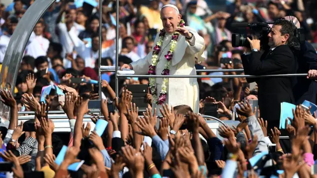 Pope Francis travels through crowds at the Mass