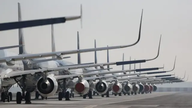 Passenger planes parked on a runway on 26 May