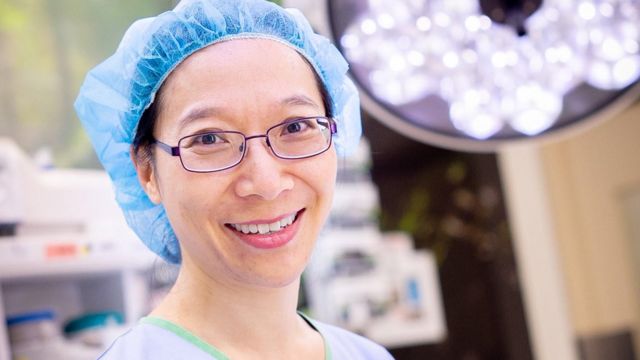 Dr Rhea Liang smiling in an operating theatre