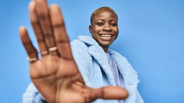 A woman with her hand reaching out
