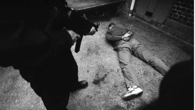 Hombre apunta a otro con un arma