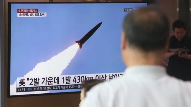 People watch missile launch on television