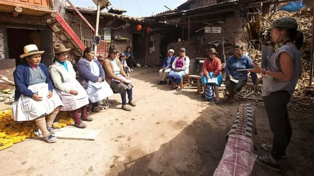 Mujer del proyecto Quipu conversando con otras mujeres