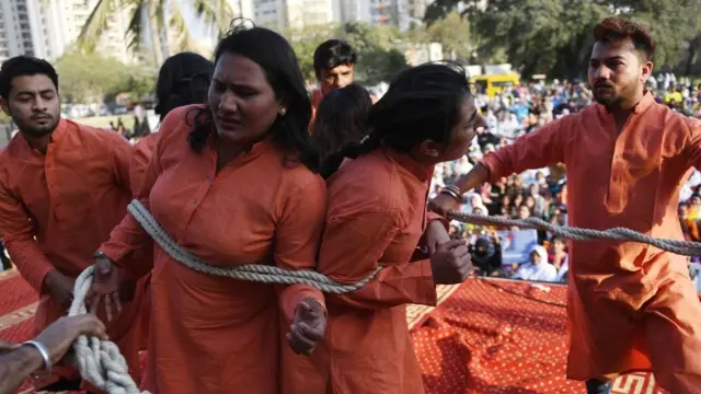 Pakistani civil society activists act a dram during a rally to mark International Women's Day in Karachi on March 8, 20