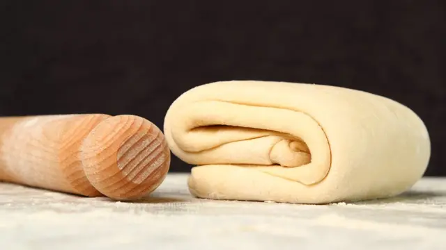 Скалка с пластом слоеного теста