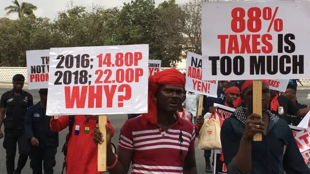 Ghana people carry placard dey protest fuel price