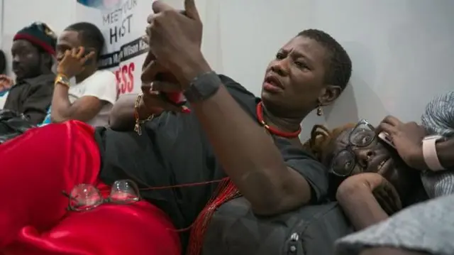 Yvonne Aki-Sawyerr na nwa ya nwanyị (R) n'isi ụlọ ọrụ APC dị na Freetown mgbe a gbagburu gas anya mmiri n'oge ọgba aghara ndọrọ ndọrọ ọchịchị na June 2023