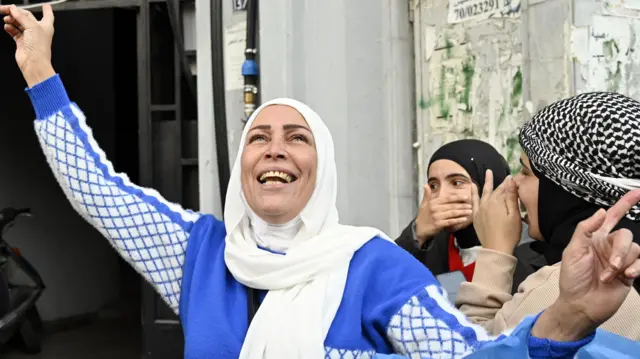 A group of women celebrate in the street