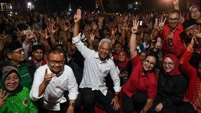 Calon Presiden nomor urut 3 Ganjar Pranowo (tengah) bersama relawan relawan melakukan salam tiga jari di Taman Ndayu Sragen, Jawa Tengah, Minggu (24/12/2023).