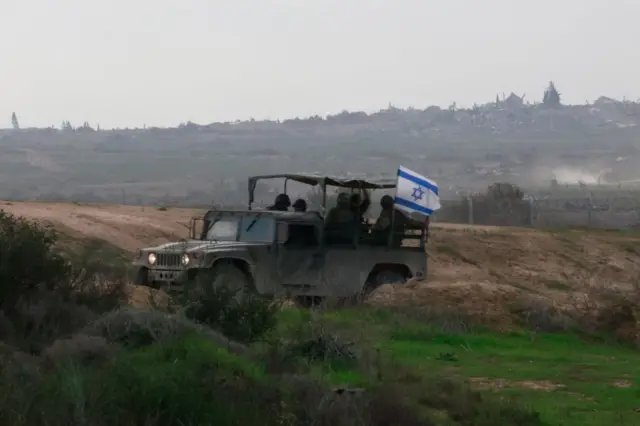 ग़ज़ा से लगती सीमा से गुजरते इसराइली सैनिक