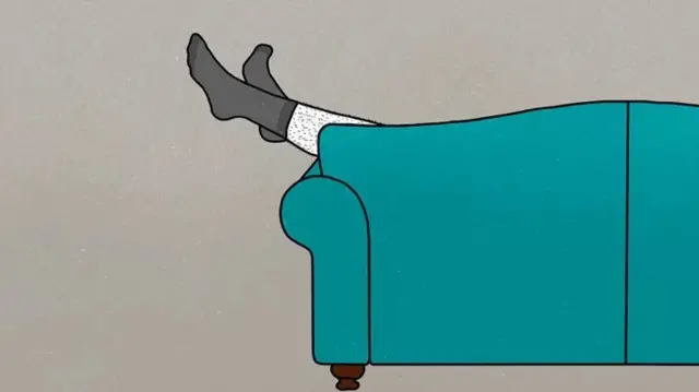 Des pieds émergeant d'un canapé.