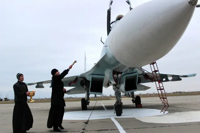 A Russian priest blesses an Su-27 fighter jet in Crimea (2014 pic)