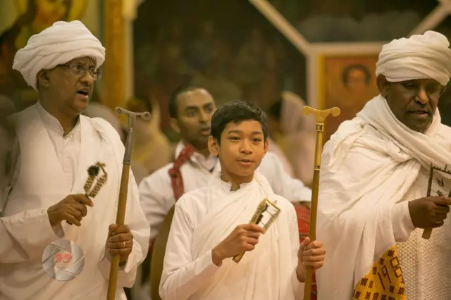 ዲያቆን ዮሐንስ አሎንዞ (ከመሐል) ከቀሳውስት ጋር