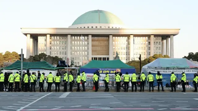 Police officers stand guard outside the National Assembly in Seoul, South Korea, 04 December 2024.