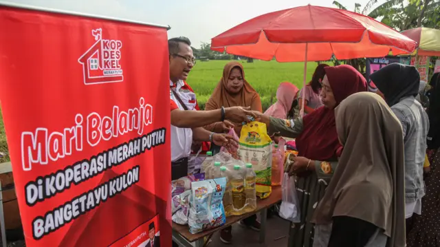 Petugas melayani warga membeli beras premium dalam acara bazar rakyat Koperasi Desa/Kelurahan Merah Putih (KDKMP) di Bangetayu Kulon, Semarang, Jawa Tengah, Minggu (1/2/2026).