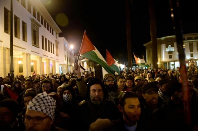أشخاص يحملون الأعلام الفلسطينية خلال مسيرة لدعم الفلسطينيين في الرباط، المغرب، 29 مارس/آذار 2024