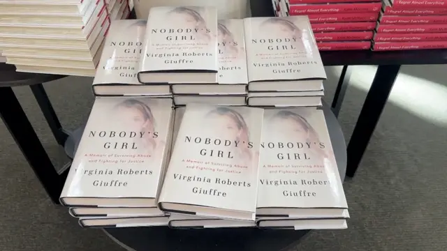 Several books titled 'Nobody's Girl' are placed on a table in a bookshop.