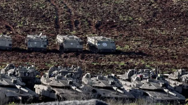 野原に灰色の戦車や装甲車が並んでいる