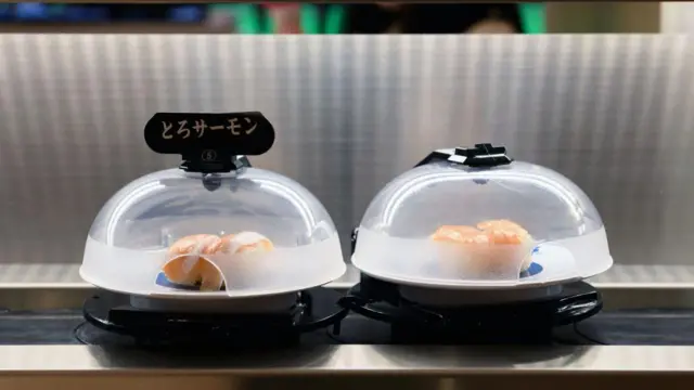 Plates of salmon sushi on a conveyor belt in Tokyo, Japan.