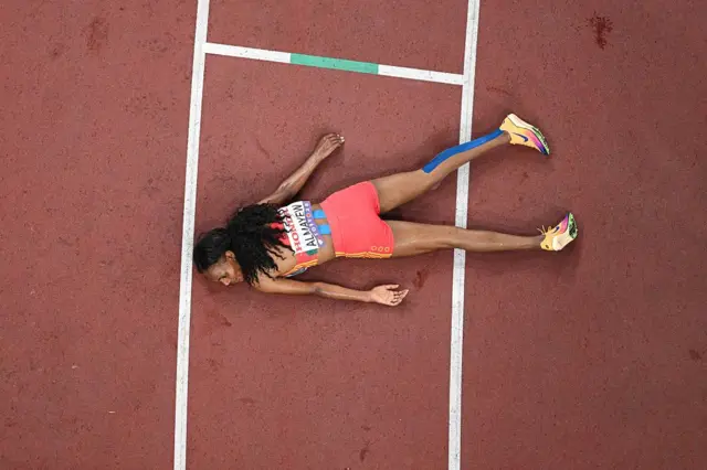 A woman lie face down on a race track.