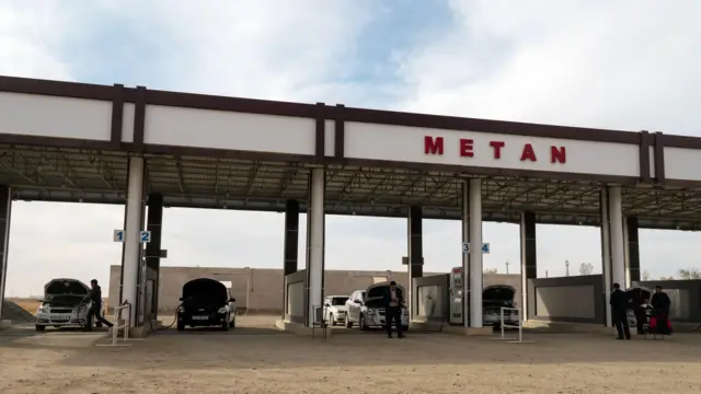 Метан гази шоҳобчасида одамлар машиналарига газ тўлдиришяпти.