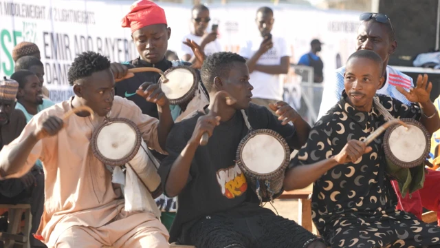 Three drummers play traditional Kalangu drums at the Emir Ado Bayero Dambe Championship