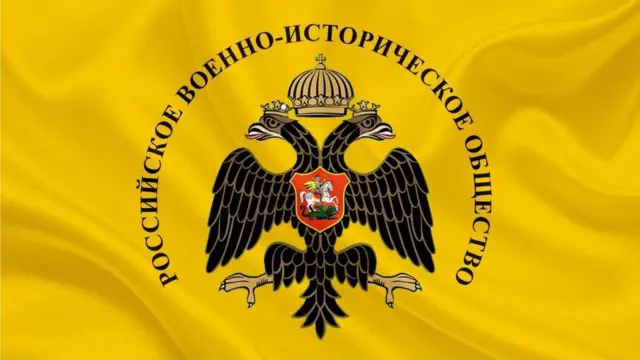 Логотип РВІТ: чорний двоголовий орел на жовтому тлі