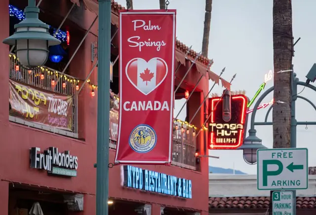 Un cartel que dice la ciudad de Palm Springs, en California, con corazón en la que se ve la bandera de Canadá.