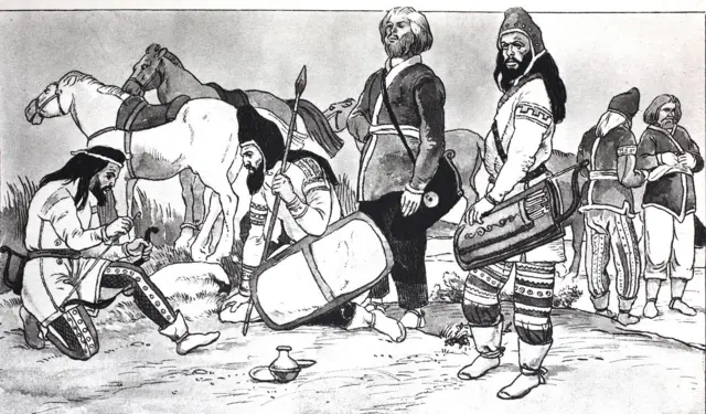 Seis hombres en un campo. Tienen barbas y están vestidos con una especie de túnica corta y pantalones. Tres de ellos llevan gorros y todos tiene calzado que está amarrado en los tobillos. Unos están sentados, otros parados. Se ven flechas, un escudo, varios caballos.