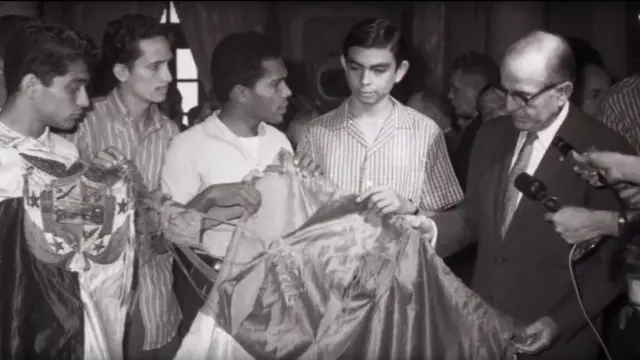 Estudiantes muestran la bandera destrozada al presidente de Panamá, Roberto Chiari.