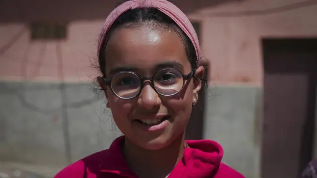 Ikhlas regarde la caméra en plan serré