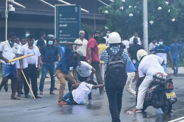 Demonstrators and government supporters clash outside the President's office in Colombo on May 9, 2022.
