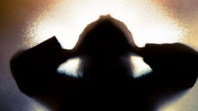 A person holds their head in a treated image