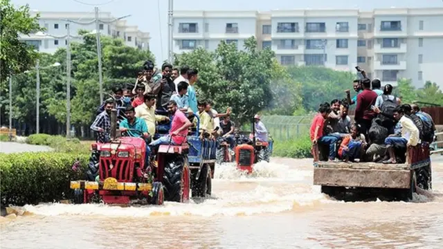 వరదల్లో ట్రాక్టర్ సాయంతో ప్రయాణిస్తున్న ప్రజలు