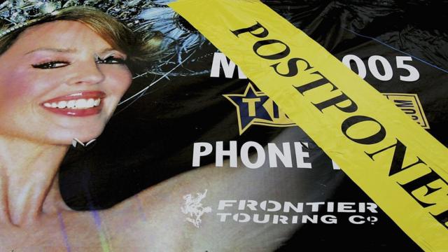 A poster promoting Australian singer Kylie Minogue's forthcoming tour is labelled with a postponed banner at Sydney Superdome on 19 May 2005 in Sydney Australia.