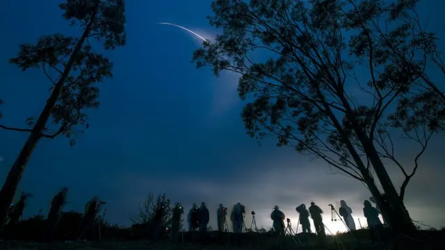 Observers at the launch of a satellite