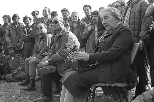 Then Israeli Prime Minister Golda Meir (R) and defense Minister Moshe Dayan meet their troops October 21, 1973 on the Golan Heights during the Yom Kippur War. 