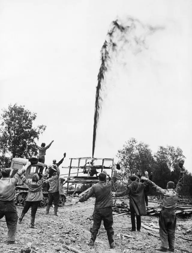 11/1/1963-Tyumen, USSR: Drillers greet a gush of oil that spouts skywards from a recently opened well in the Tyumen region of Soviet Russia's Siberia. According to an official Soviet source, oil extraction for industrial purposes will begin in 1966.