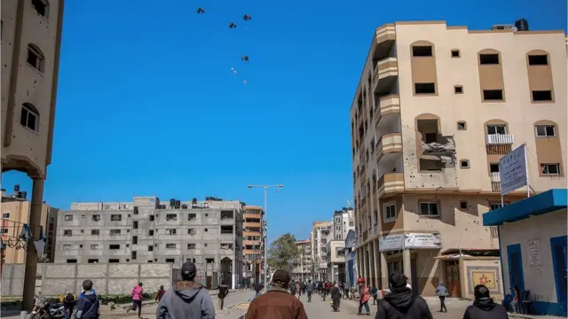 Aid parcels are airdropped over the northern Gaza Strip on 8 March