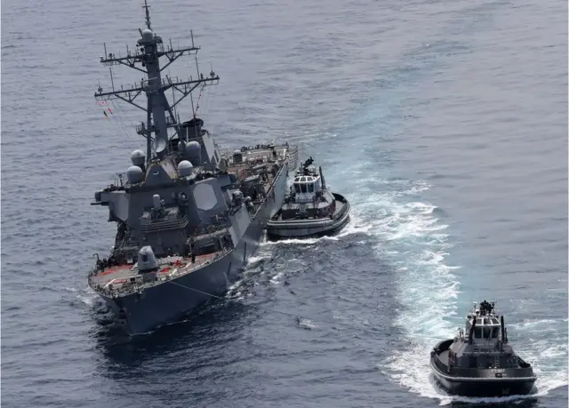 guided missile destroyer USS Fitzgerald next to tugboats off the Shimoda coast after it collided with a Philippine-flagged container ship on June 17, 2017.