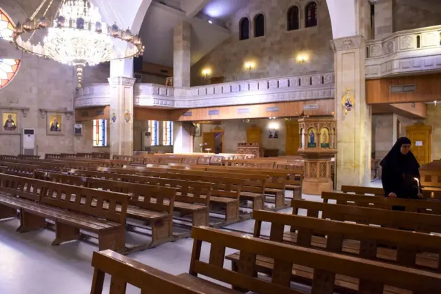 راهبة تشارك في قداس بكنيسة في مدينة حلب شمالي سوريا